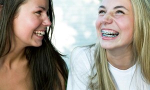 two girls facing each other, laughing